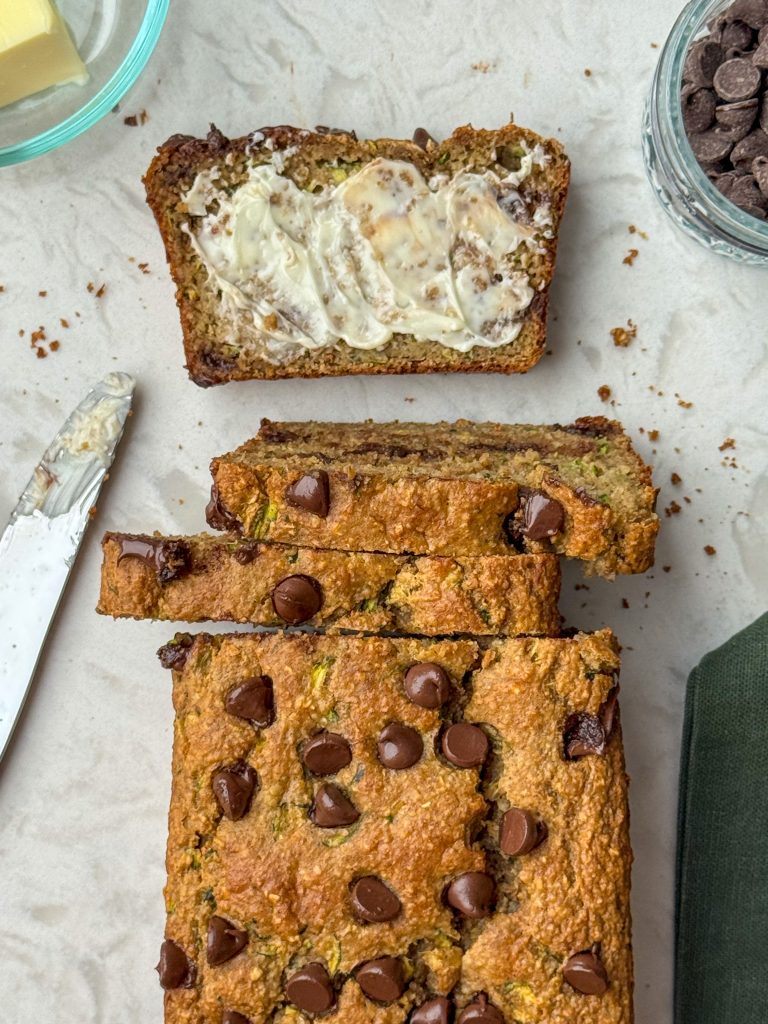 Healthy chocolate chip zucchini bread with butter and a butter knife.