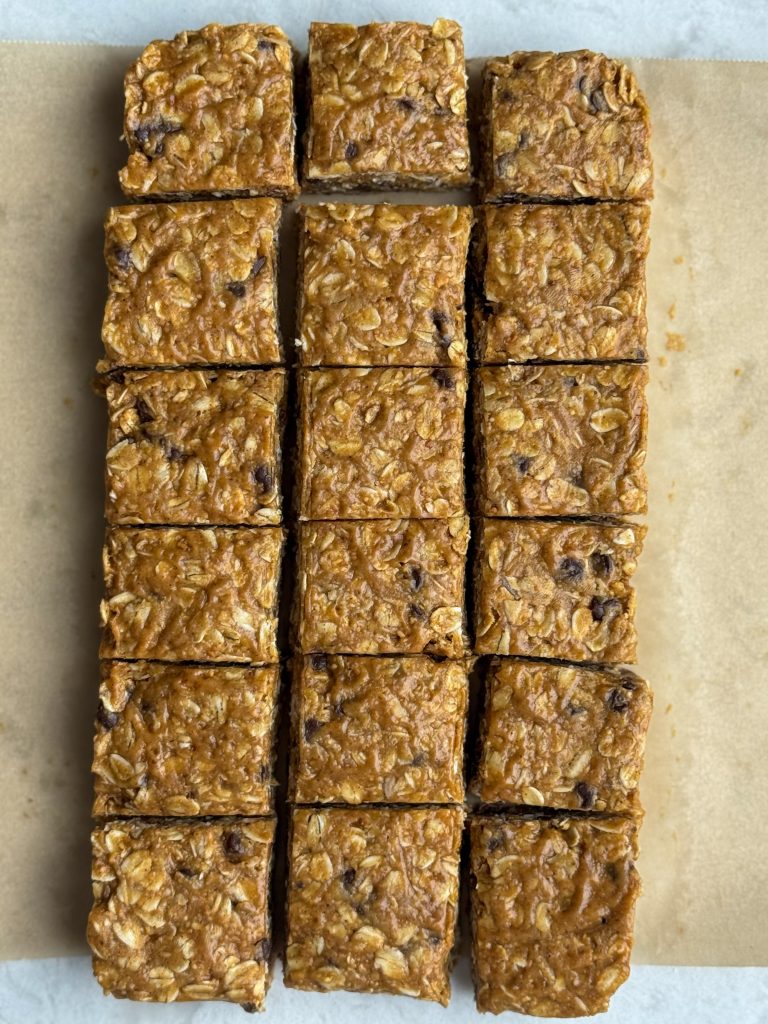 No bake chocolate chips sea salt granola squares on brown parchment.
