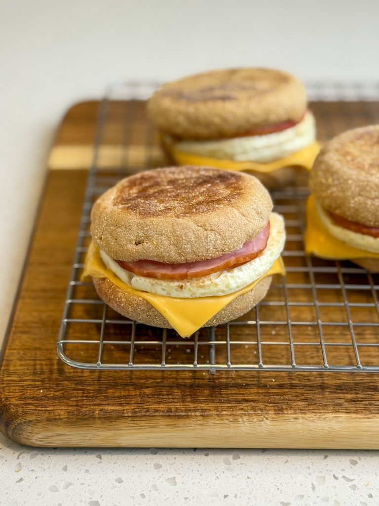 Copycat egg McMuffins with egg, cheese, canadian bacon on a english muffin.