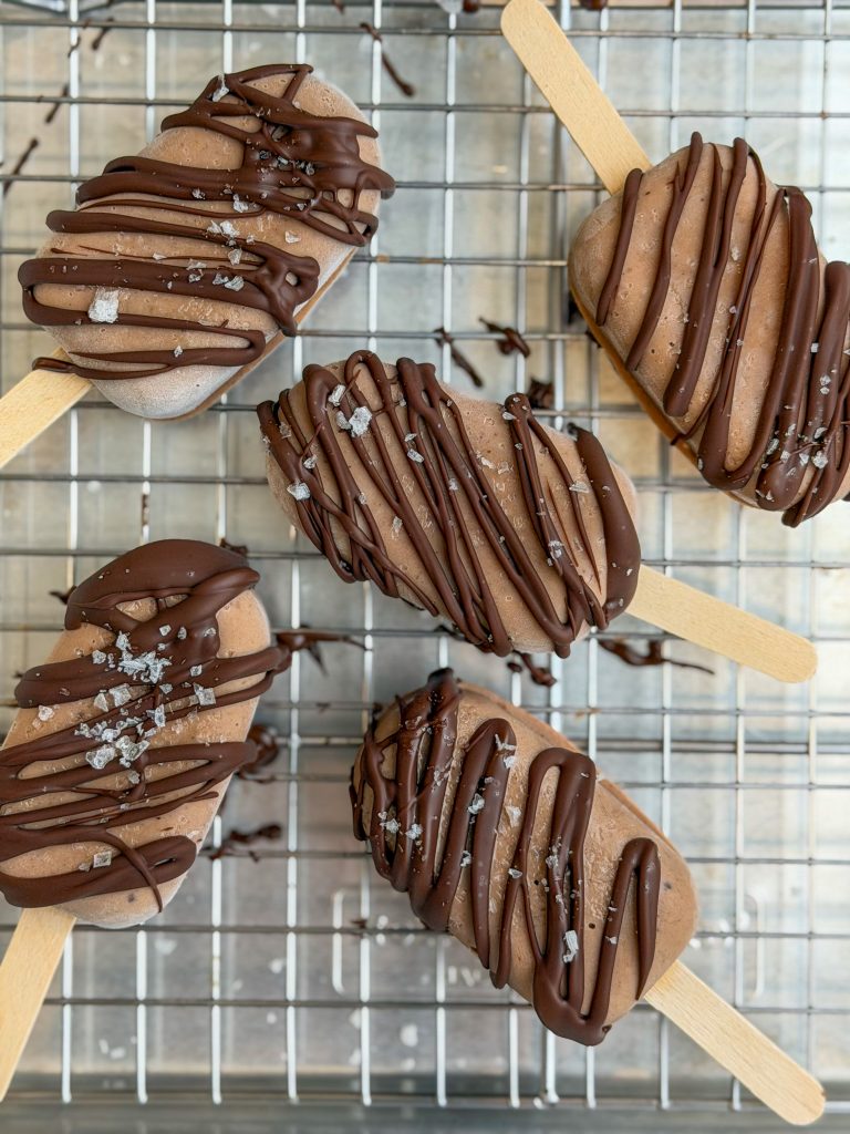 Frozen easy chocolate banana yogurt pops drizzled with chocolate and topped with flaky salt.